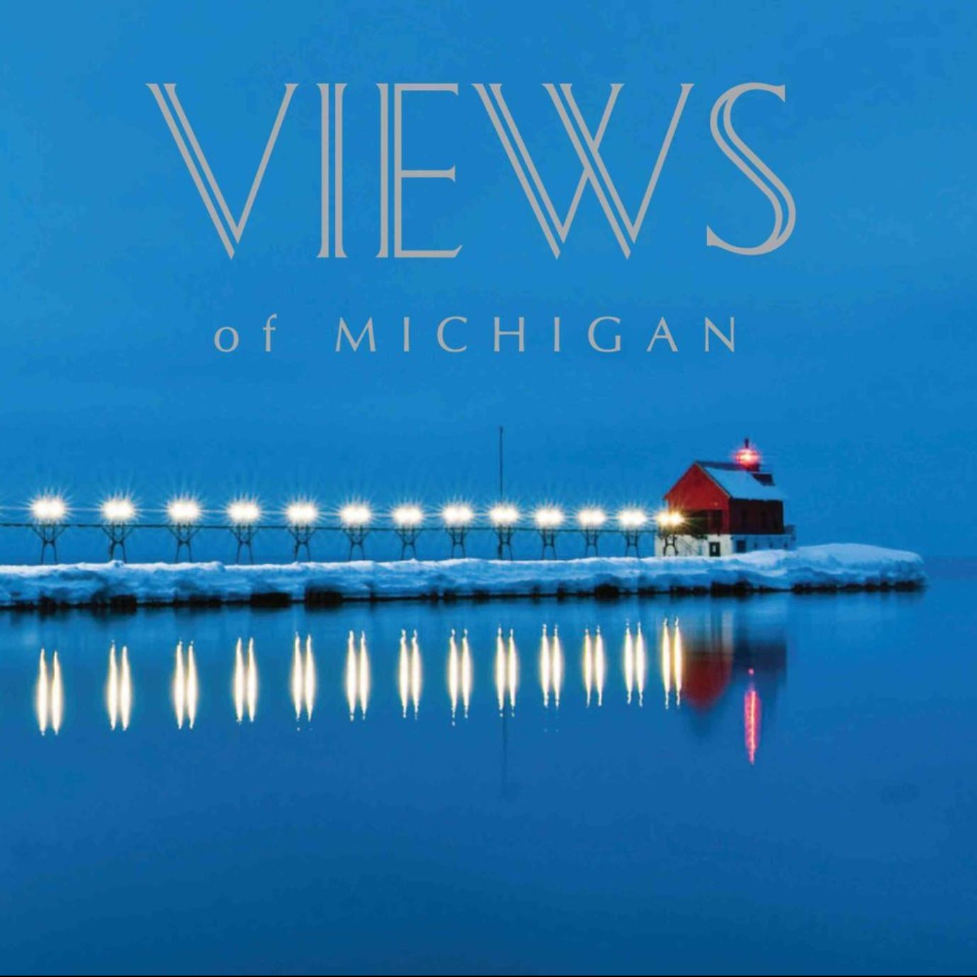 A blue book cover featuring a red lighthouse over water on a winter evening.